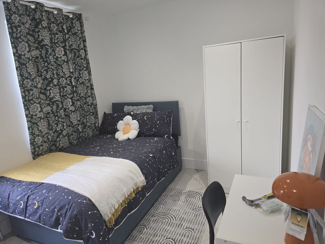 YCN Colney Home bedroom with navy constellation bedding and wardrobe — cosy, personalised space for young people